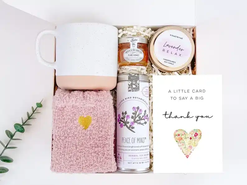 Thank you gift box with white/pink coffee mug, pink socks, candle, and thank you card. 