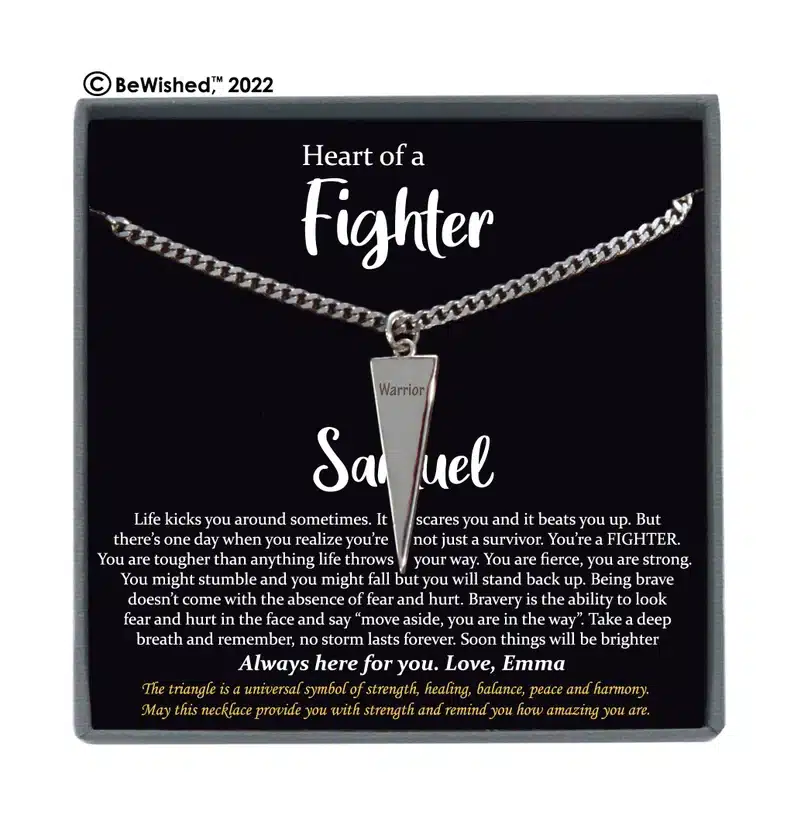 Get Well Gifts for Men: Black box with a silver necklace with a sharp tringle charm that says Warrior on it.