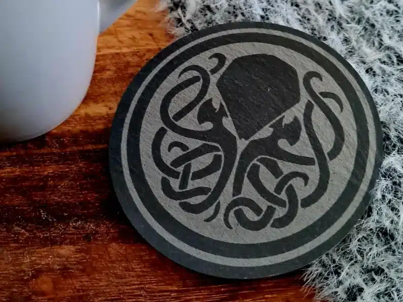Housewarming Gifts for Geeks: Round wooden Cthulhu coaster. 