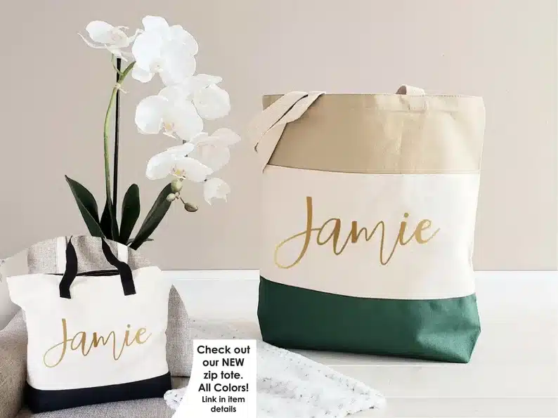 Tan, white, and green tote with gold font that says Jamie. 