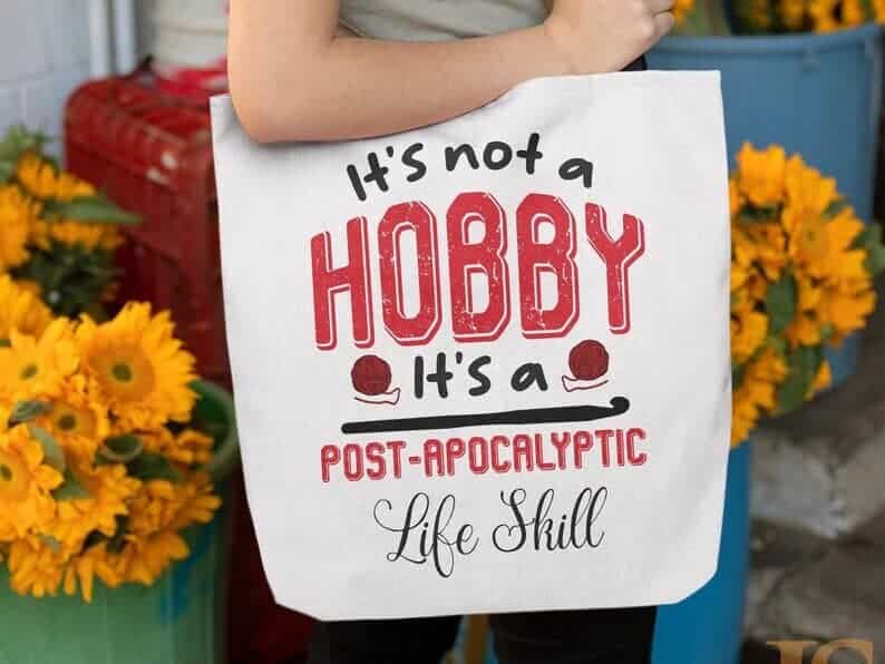 White bag with black font and red font that says "it's not a hobby it's a post apocalyptic life skill"