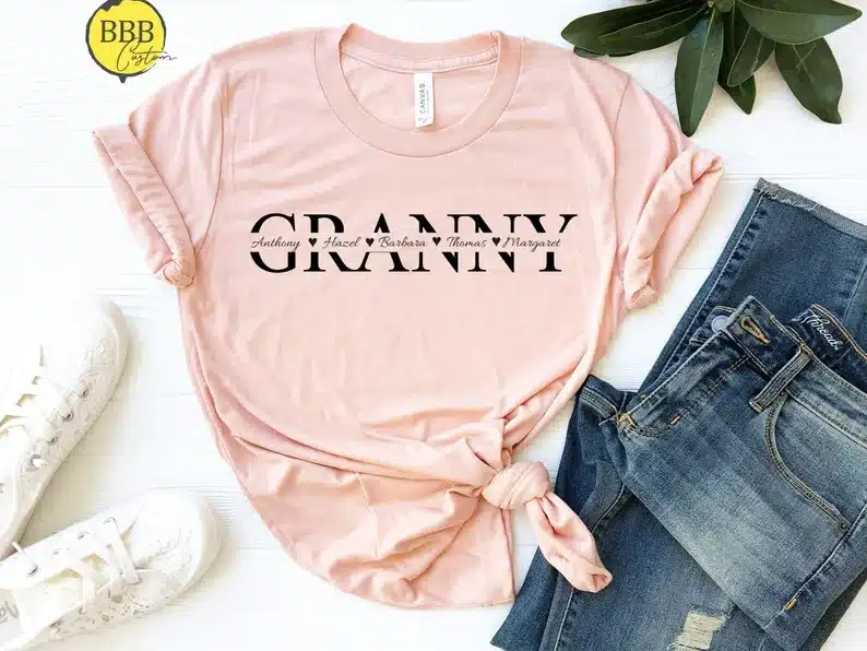 Light pink t-shirt with black font that says GRANNY with grandkids names through it. 