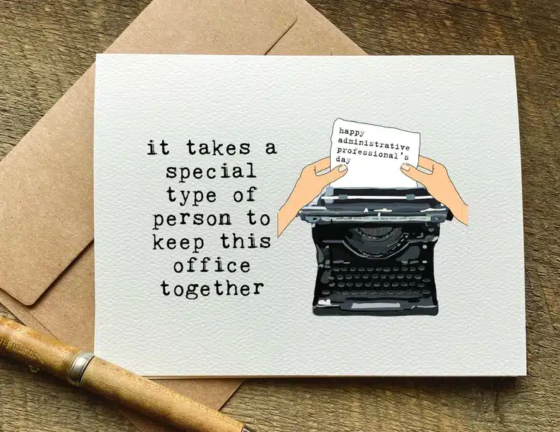 White card with a black typewriter that says it takes a special type of person to keep this office together. 