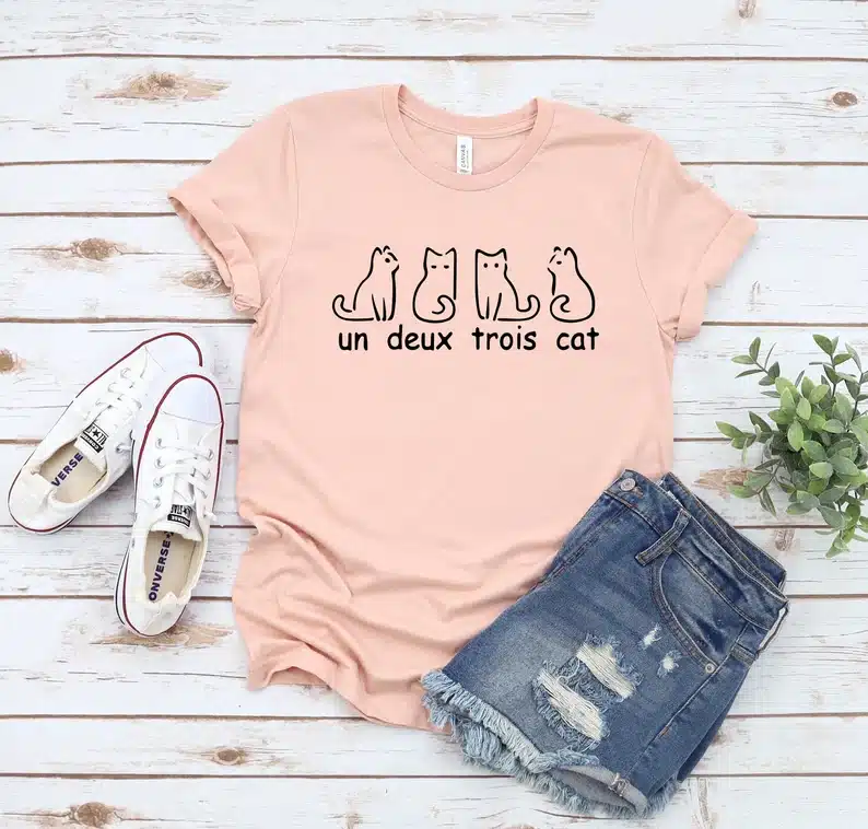 Light pink t-shirt with cats on them. 