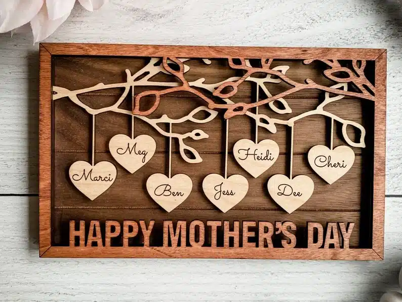 Wooden family tree, with hearts hanging with names of family member son them. 