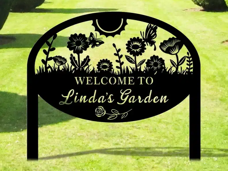 Black metal custom garden sign. this one with flowers and butterflies that says Welcome to Linda's Garden. 