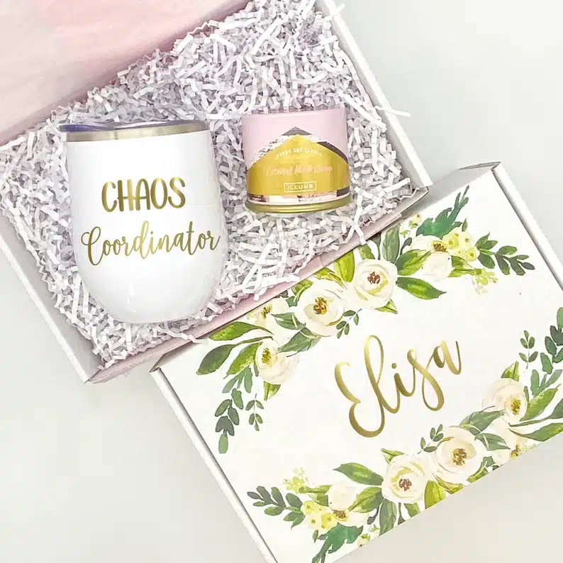 Administrative Professionals Day Gifts: Box with a wine tumbler that says Chaos coordinator on it and a candle. 