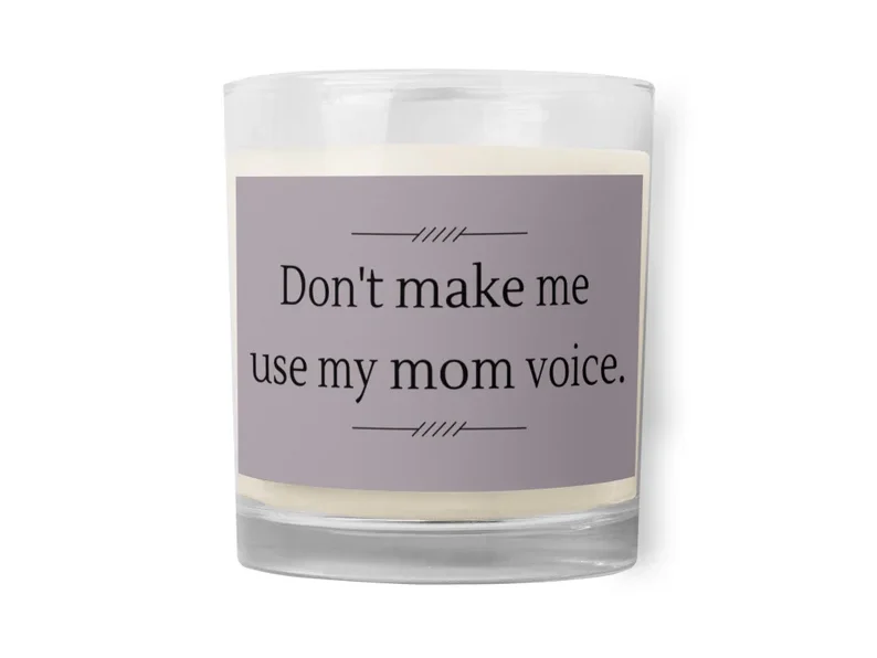 Clear jar with a light grey label with black font it says Don't make me use my mom voice. With a white candle in jar. 