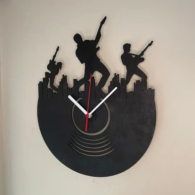 Black vinyl made into a clock and the top cut out to have three rockers rocking out. 