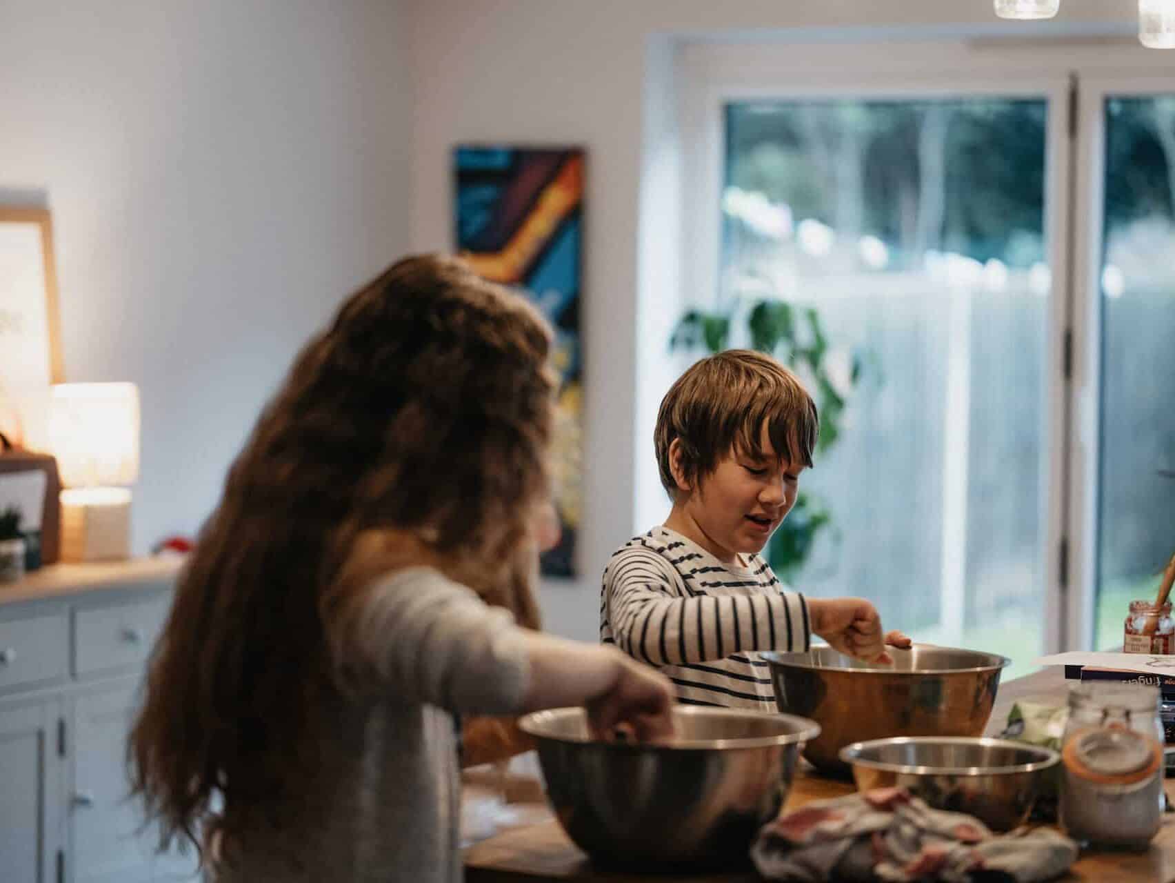 Mother’s Day Gifts for Sister-in-Laws: kids cooking in the kitchen taking a cooking class