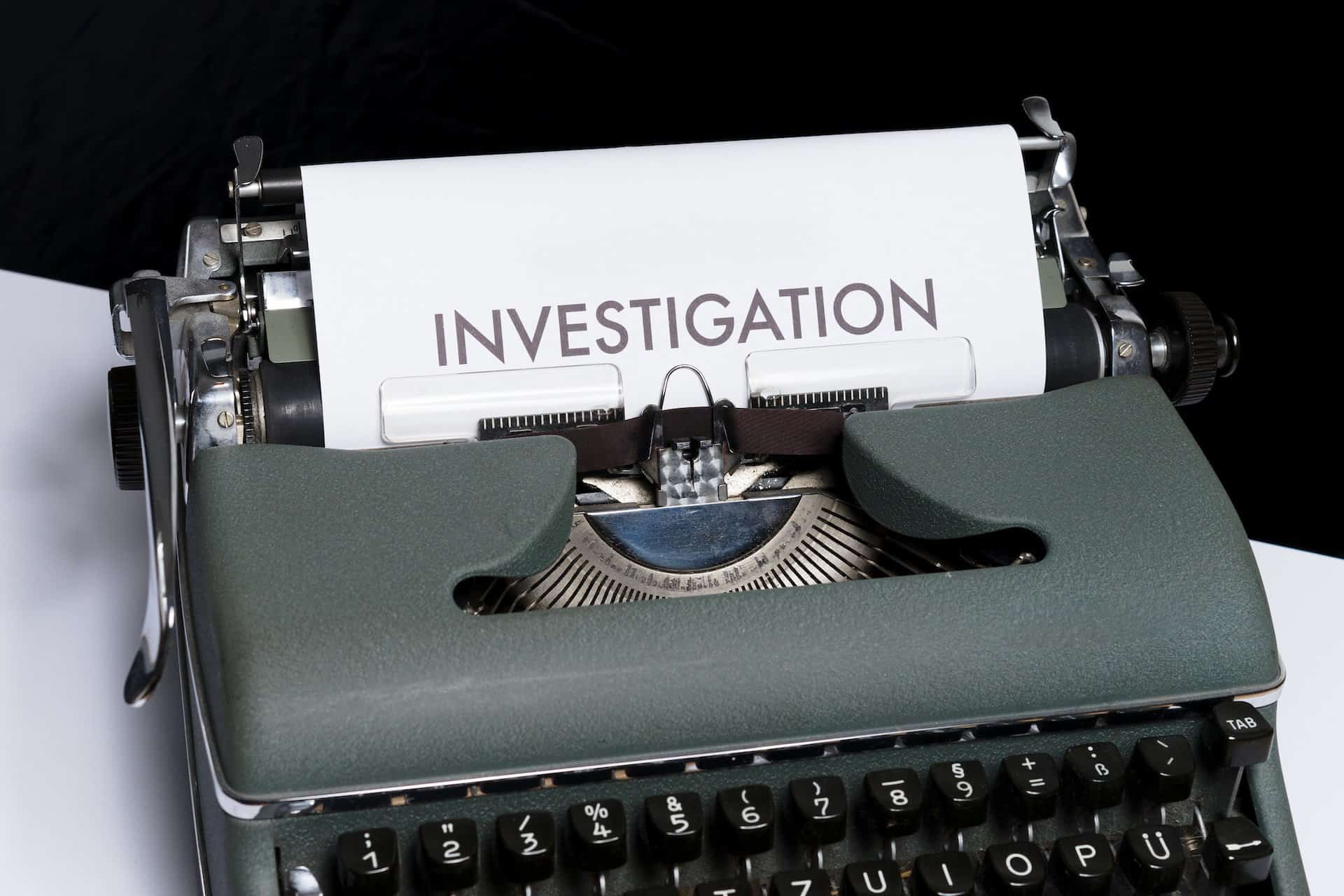 Typewriter that is printing "investigation"