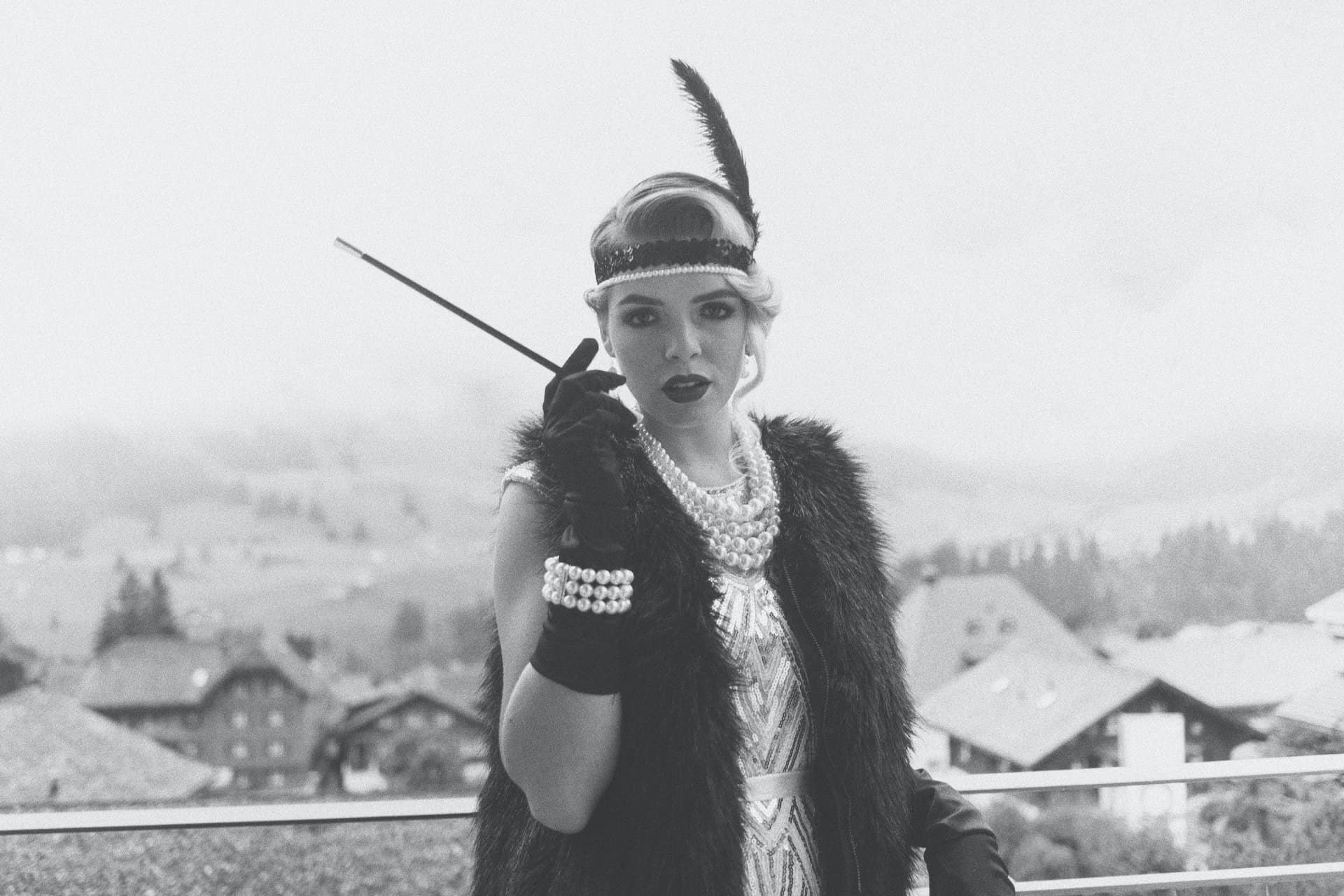 Woman dressed in a 1920s outfit in character at a murder mystery party