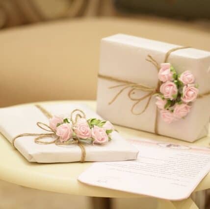 Luxury wedding gift wrapping idea with mini roses attached with jute twine