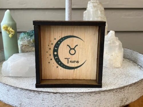 Gift Ideas for the Taurus Woman: Small square wooden sign with Taurus symbol and crescent moon on it.
