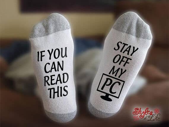 Father's Day Gifts For Computer Geeks - White socks with grey tips and black text, one sock says If you can read this, the other says Stay off my PC.