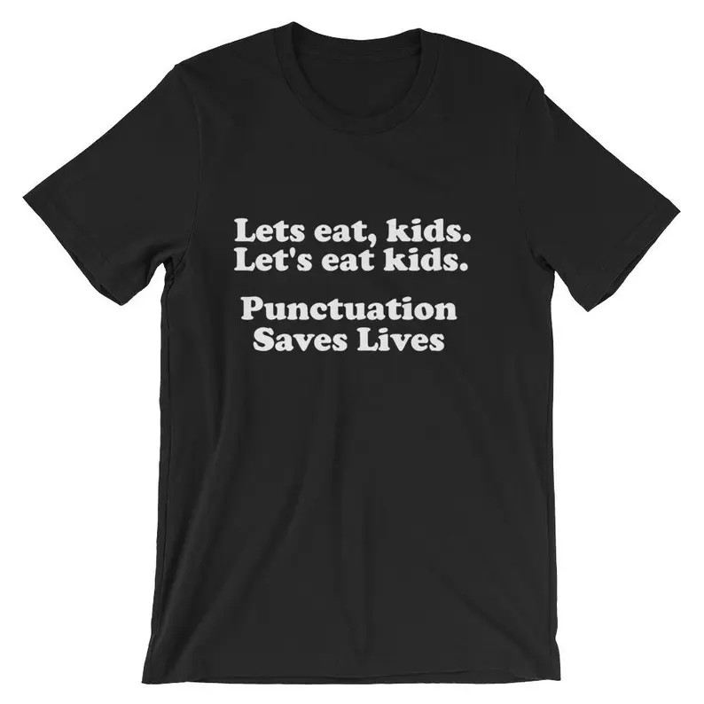 Black t-shirt with white font that says Lets eat, kids. Let's eat kids. Punctuation saves lives. 