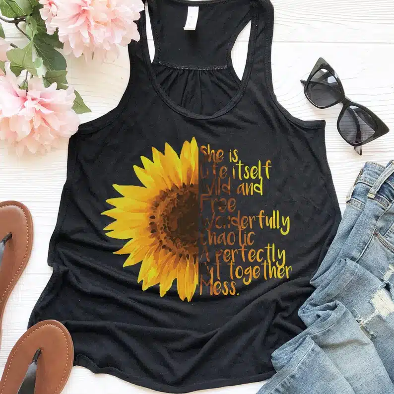 Black tank top with half sunflower on it with yellow font on the other side. 