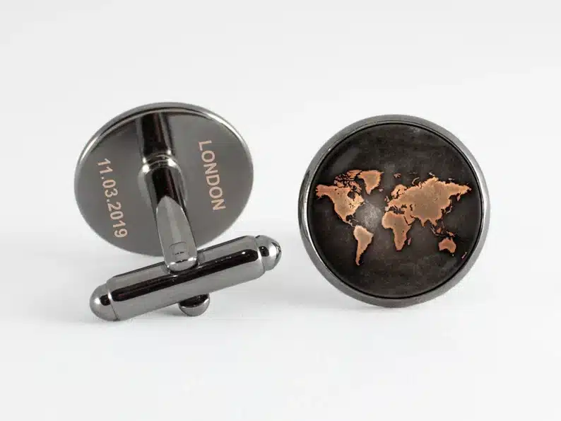 Silver cufflinks with round world map on them. 