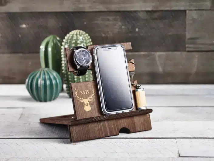 Wooden customized dock that holds watch, cellphone, and keys. 