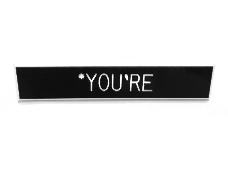 Black sign that says *You're 