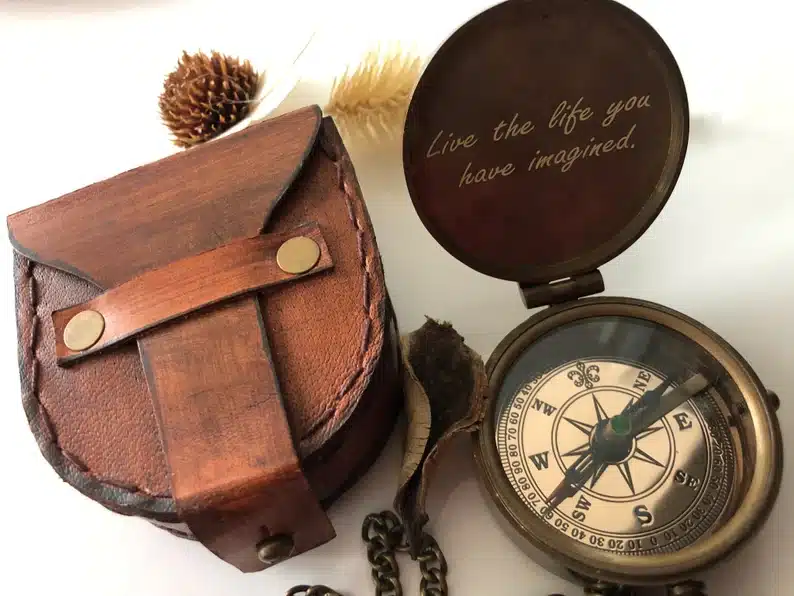 Engraved bronze compass with leather case for it. 