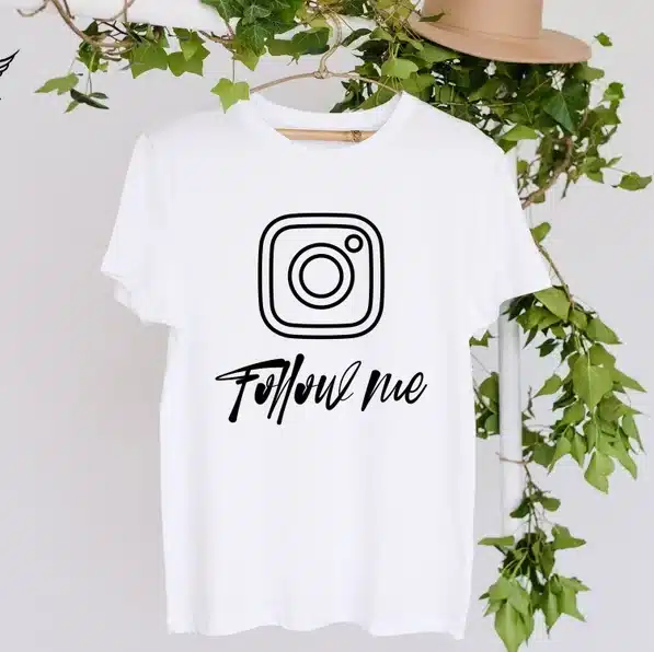 White tshirt that says follow me with an instagram symbol on it in black. 