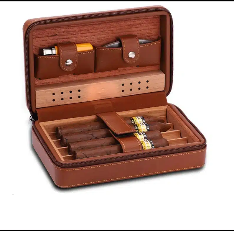 Brown leather cigar case opened showing four cigars and two lights on the lid part. 