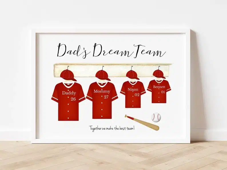 Customized wall price with dads dream team on it, with four red baseball uniforms hanging up with names on them. 