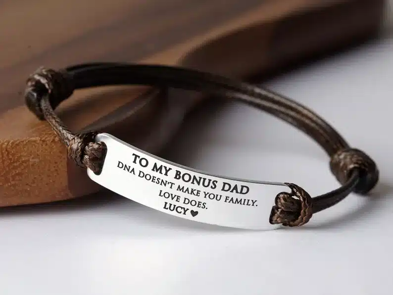 Dark brown leather bracelet with silver rectangle charm that says to my bonus dad DNA doesn't make you family love does. Lucy. 