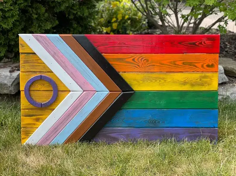 Wooden sign made ti look like the pride flag. 