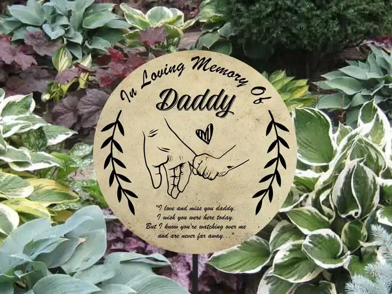 Round memorial stake that says in loving memory of daddy. 