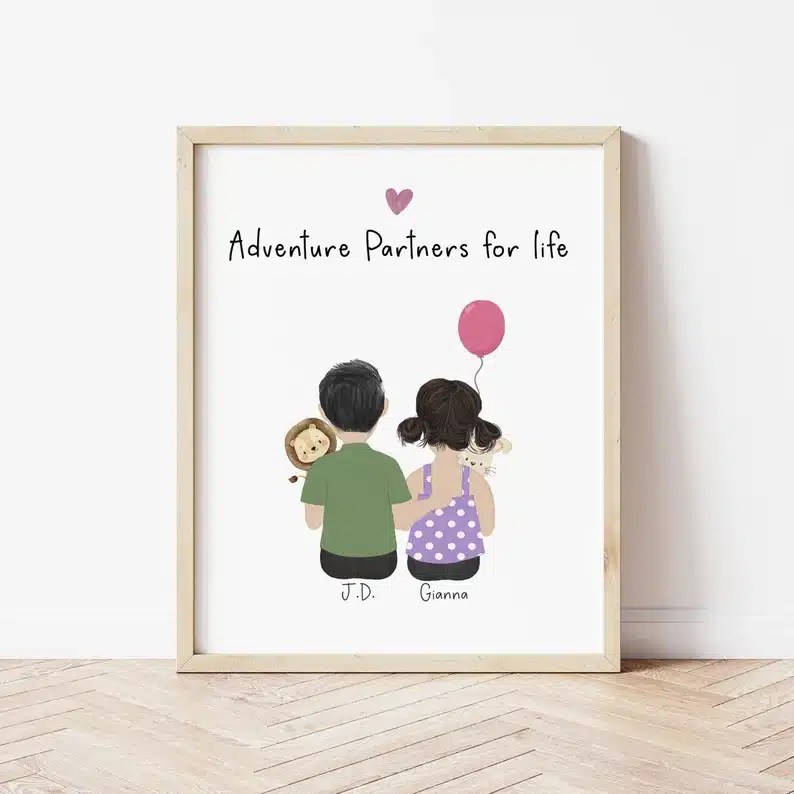 Light wood frame with white print of a man and woman. that says adventure partners for life. 