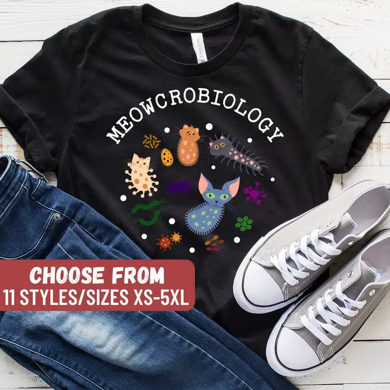 Black t shirt that says meowcrobiology shirt with germs as cats. 