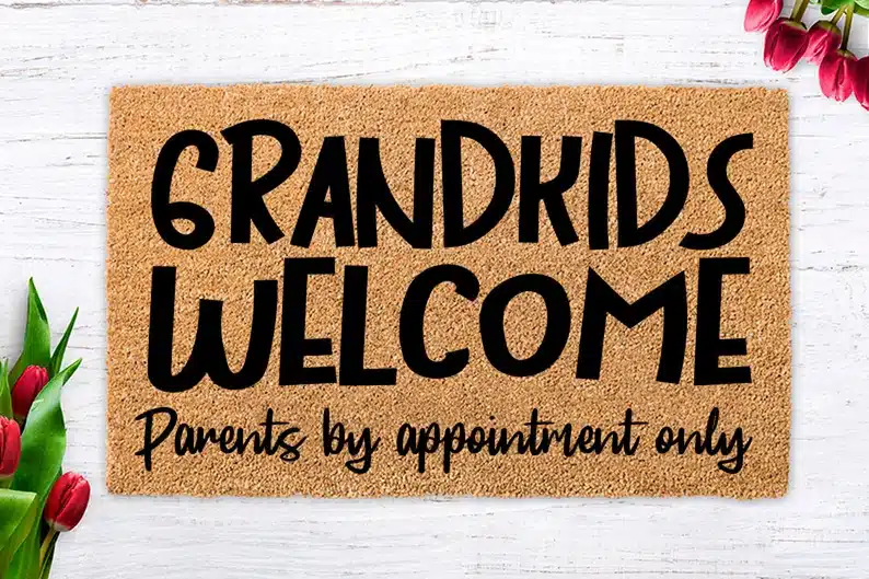 Brown welcome mat that says "Grandkids welcome parents by appointment only" in black ink. 