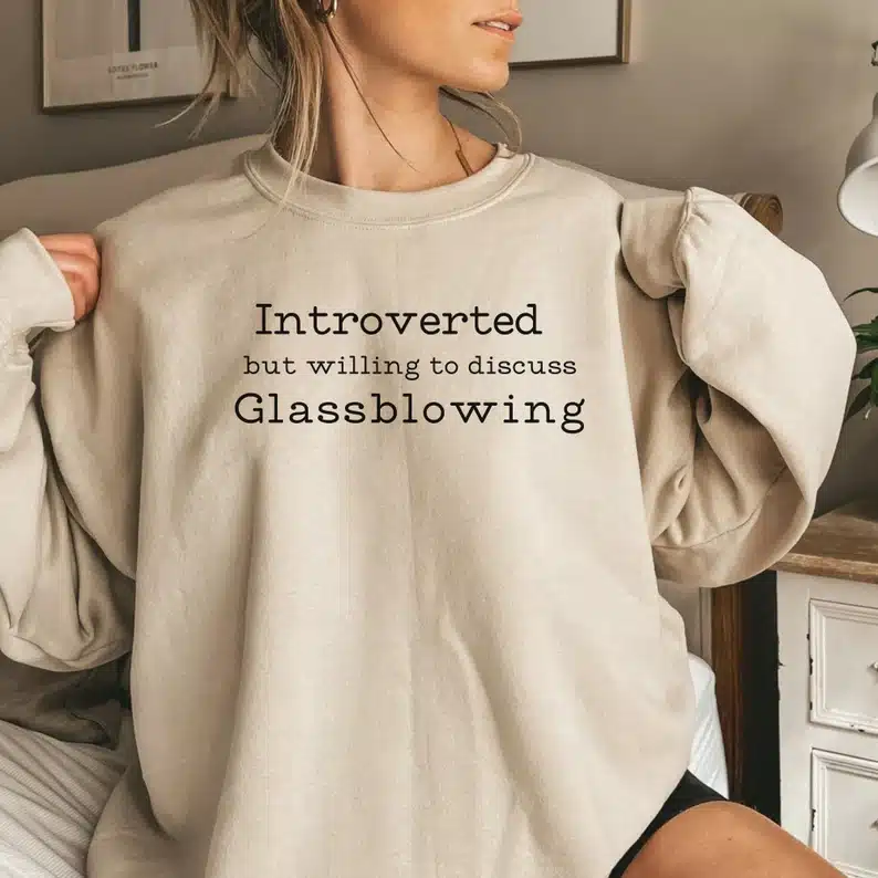 Gifts for a Glassblower - Woman wearing a tan colored long sleeve sweatshirt thatsays 