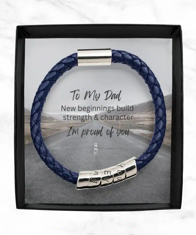 Blue man bracelet with a saying on the box that says To my dad new beginnings build strength & character I'm proud of you. 