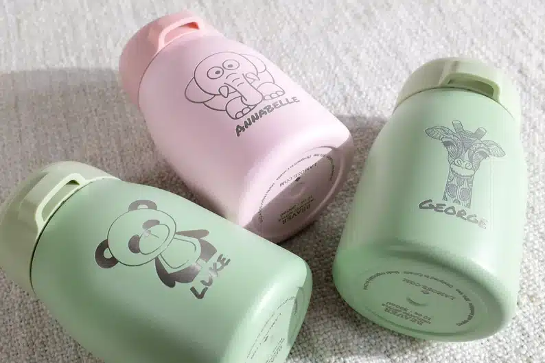 Camping Gifts For Kids - Three custom insultaed kids bottles, two mint green and one pale pink. 