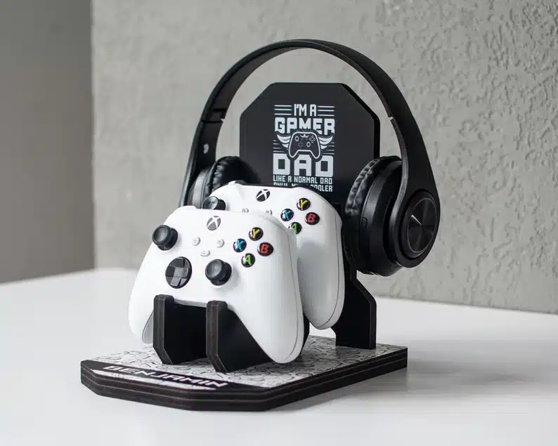 Gamer dad controller holder with headphones and two white xbox controller. 