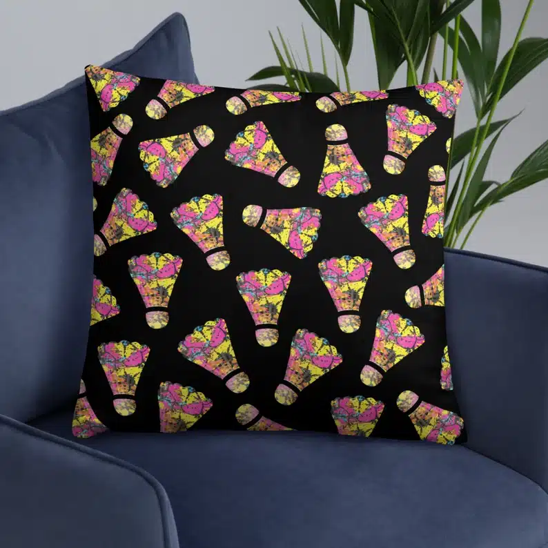 Black square pillow with colorful birdies all over it. 