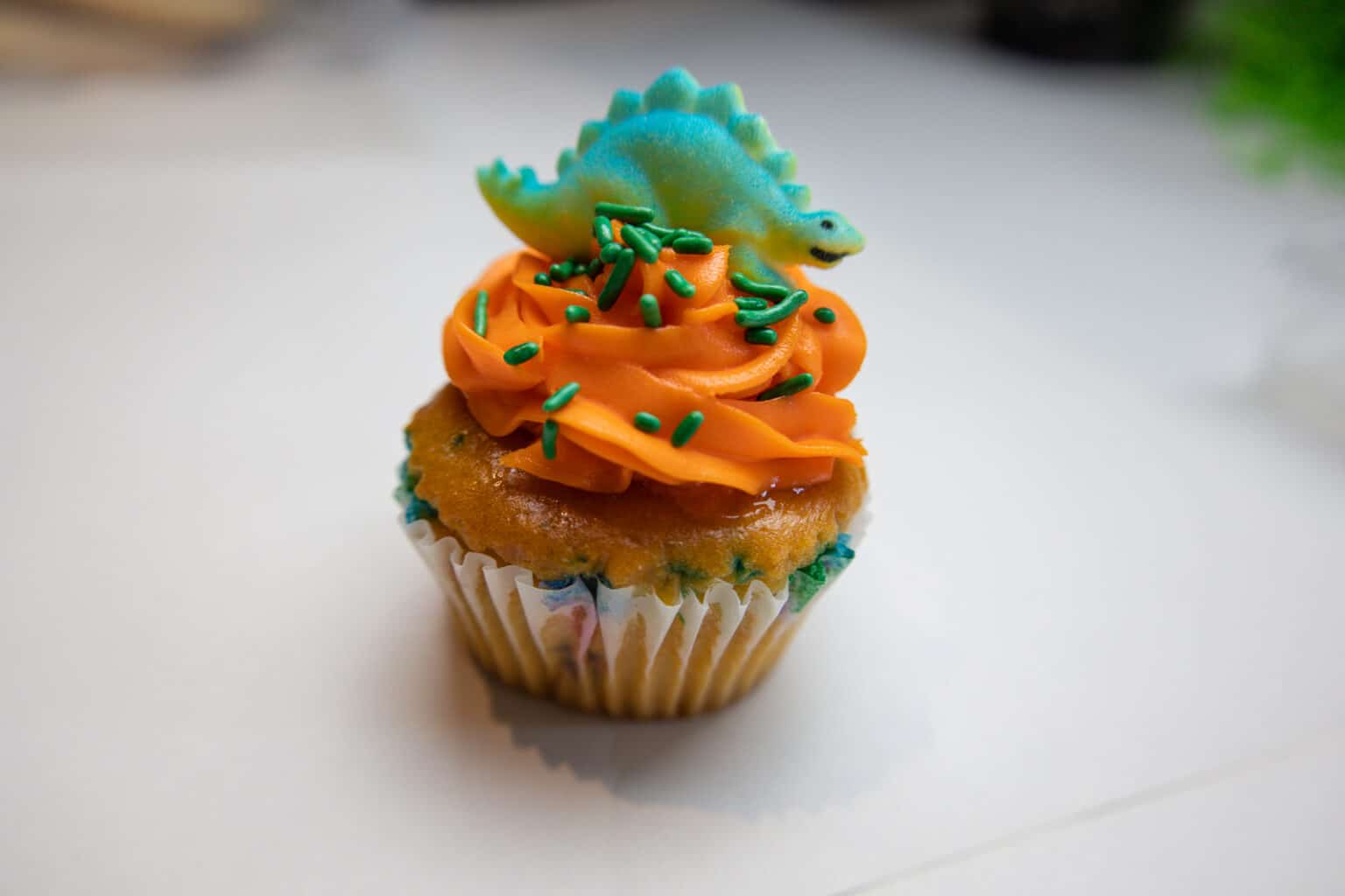 Cupcake with a dinosaur on top