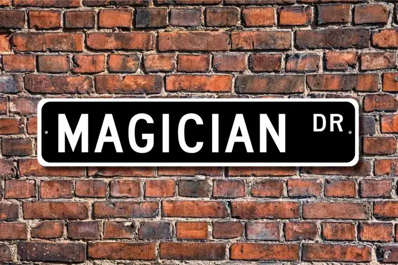 Gifts for a Magician - Brick wall with a black street sign with white text that says "Magician Dr." 