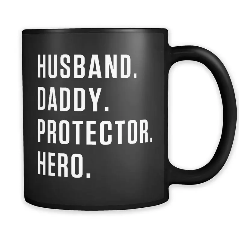 Black coffee mug with white font that says Husband. Daddy. Protector. Hero. 