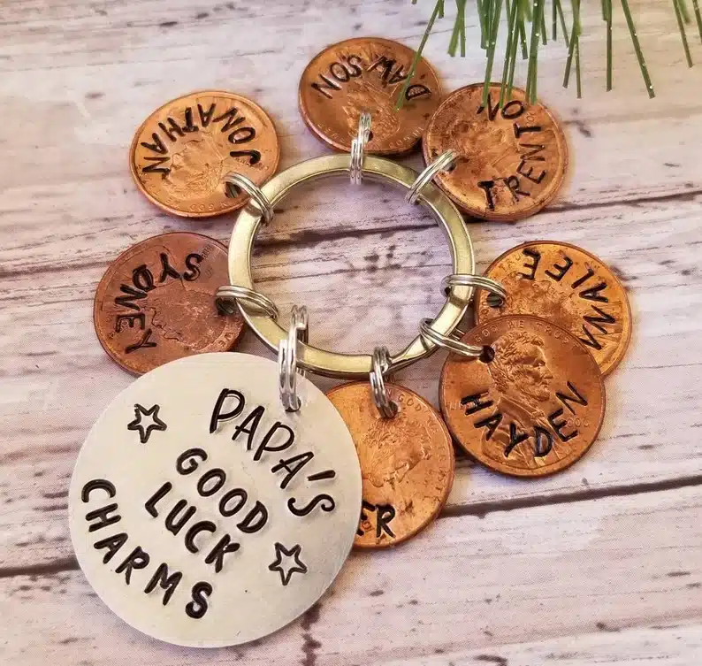 Keychain that says Papa's good luck charms with pennies with grandkids names on them. 