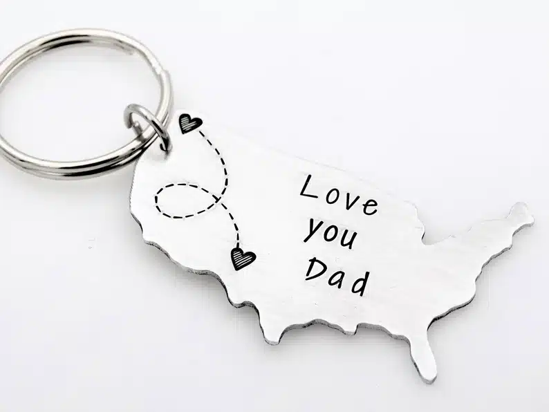 silver keychain of the USA with two hearts where kid and dad is. 