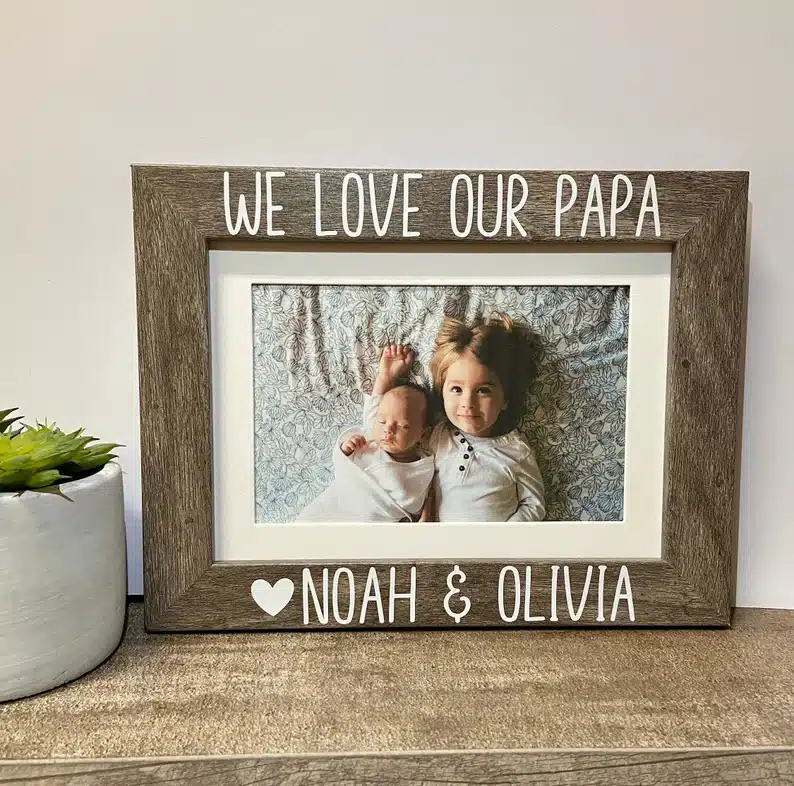 Father’s Day Gifts For Papa - wooden frame with two grandkids on it that says WE love our papa Noah & Olivia. 