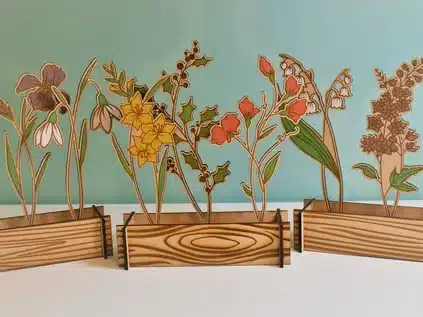 Personalized family garden. various wooden bases with different types of flowers sticking out of it. 