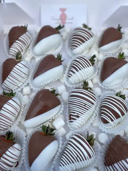White plate with chocolate covered strawberries on it. 