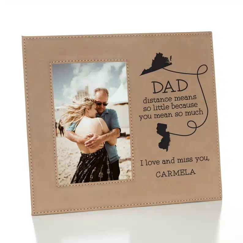 Photo frame with dad and daughter hugging with saying beside it. 