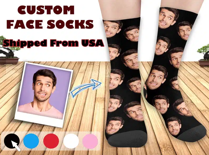 Black socks with a mans face all over them. 