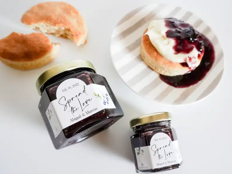 The Most Delicious Edible Wedding Favors - mini jar of blueberry jam with a scone beside it covered in jam. 